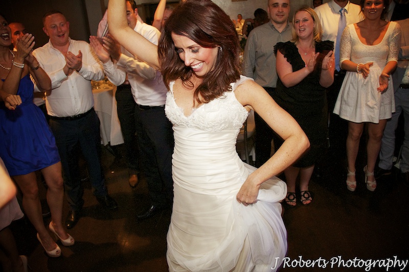 Bride into the action on the dance floor - wedding photography sydney